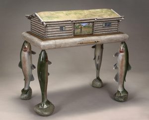Maine woodworker, sculptor and furniture maker Thomas Dahlke’s sense of visual humor extends to tables, desks and cabinets with deer feet, sheep legs and horses’ hooves, all beautifully carved and embellished with miniature paintings. 